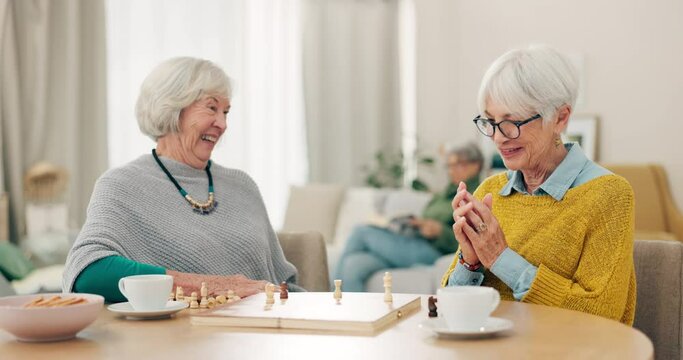 Senior woman, friends and high five for chess match, game or winning on table together at home. Happy elderly women in celebration, playing strategy board games for victory or checkmate in retirement