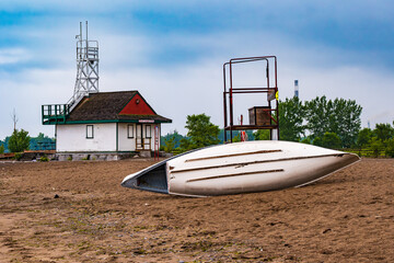 lifguard row boats chained to an observation chair on a beach in the morning.  shot on kew beach,...