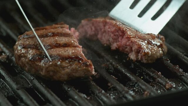 Hamburger on grill in slow motion