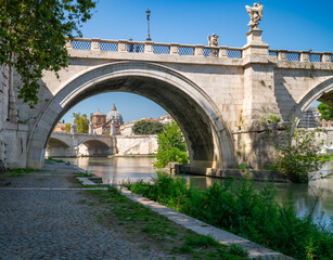 Dome of St.Peter's basilica in Vatican viewed through the bridge near Tiber river	
