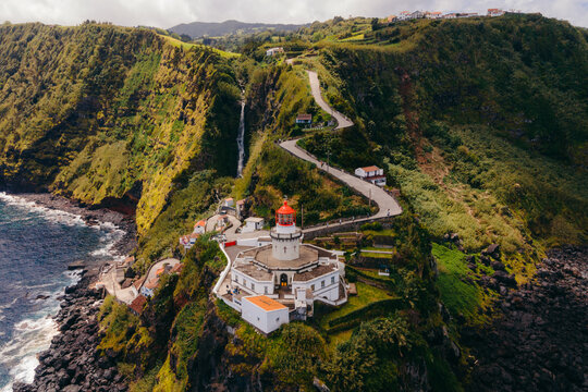 Farol do Arnel is a graceful lighthouse on Sao Miguel Island, Azores, guiding seafarers with its luminous presence and maritime history. High quality photo