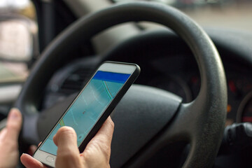 Close-up of female hand holding her phone with navigation