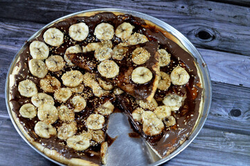 A sweet baked pastry of chocolate pizza that baked in the oven then covered with melting chocolate...
