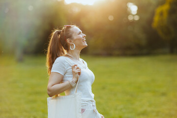 Fototapeta premium smiling trendy 40 years old woman in white shirt
