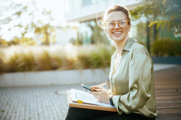 happy business woman in green blouse and eyeglasses