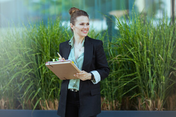 smiling modern woman employee near business center