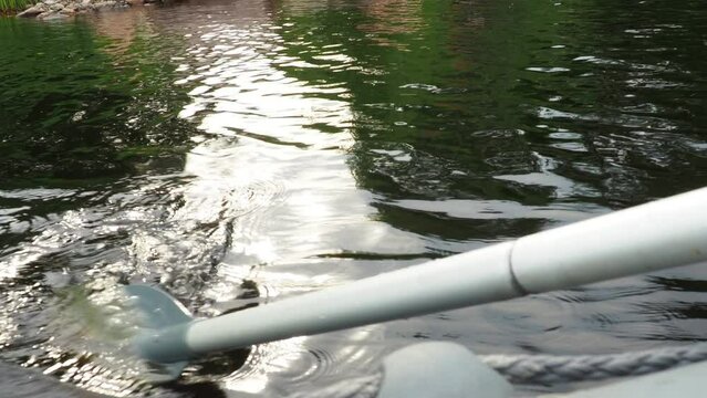 Oar - a special device propulsion in the form of a narrow shovel for setting small vessels in motion by rowing acts on the principle of a lever. Fishing on Lake Lososinnoye, Karelia. Rubber boat.