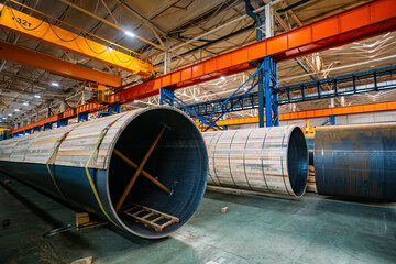 New steel pipes packed in wooden formwork in warehouse