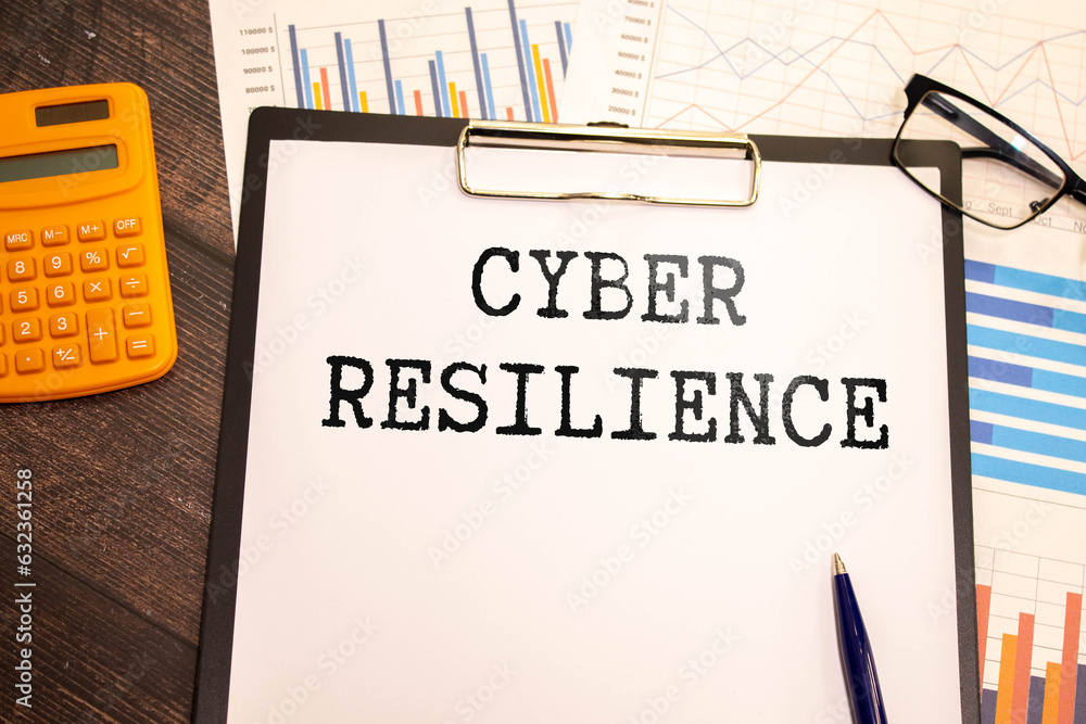Poster cyber resilience, text on white notepad paper on gray background. notepad on white keyboard.