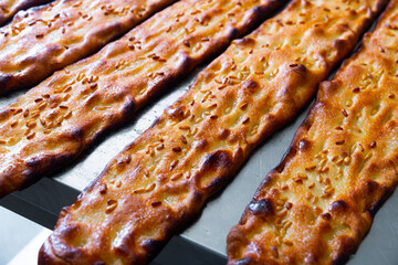 Appetizing hot sesame bread called coca. Spanish cuisine