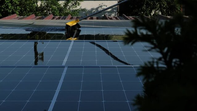 washing solar panels on the roof with water. fast motion .Solar Panel Efficiency.solar power technology.renewable energy.Alternative natural energy sources. 4k footage