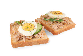 Delicious sandwiches with tuna, greens, cucumber, boiled egg and spices on white background