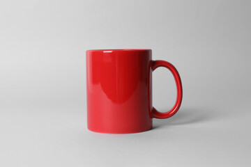 Red ceramic mug on light grey background