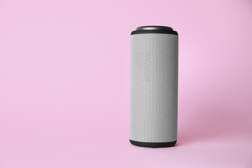 One portable bluetooth speaker on pink background, space for text. Audio equipment