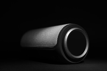 One portable bluetooth speaker on black background, closeup. Audio equipment