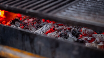 hot coals burning in a fireplace parrilla-type barbecue focusing on the embers