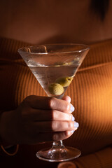 hand holding a glass of martini