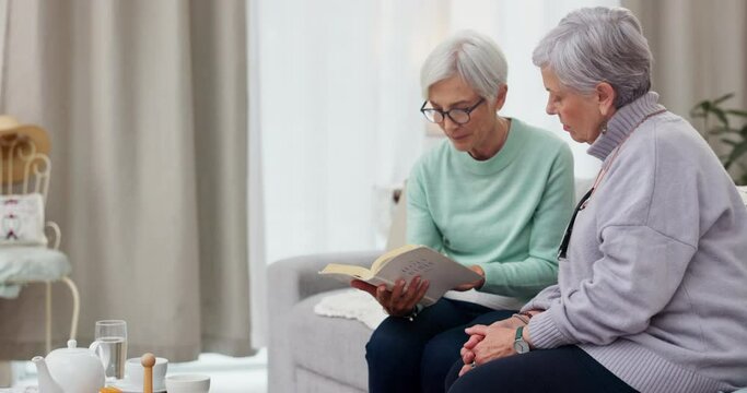 Reading, book club and elderly woman friends on a sofa in the living room of a home together. Retirement, conversation or hobby and senior women storytelling with a fiction novel in the house
