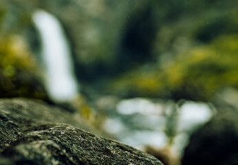 Fototapeta na wymiar Surface of stone on the background of waterfall 