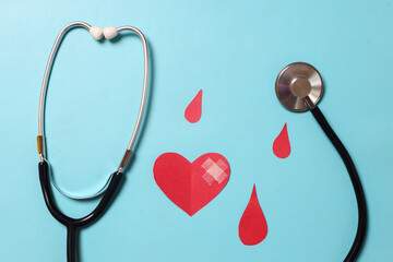 World donor day concept. Blood drop symbol with stethoscope on blue background. Hemophilia day,...