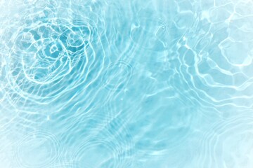 Blue water with ripples on the surface. Defocus blurred transparent blue colored clear calm water surface texture with splashes and bubbles. Water waves with shining pattern texture background.