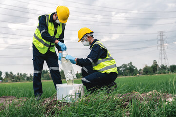 Two Environmental Engineers Take Water Samples at Natural Water Sources Near Farmland Maybe...