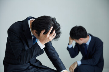 頭を抱えるビジネスマン　Business