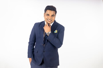 Young and confident businessman standing on white background.