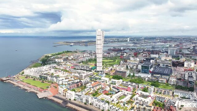 Malmo, Sweden drone cityscape over Turning Torso skyscraper, reveal commercial and residential area.