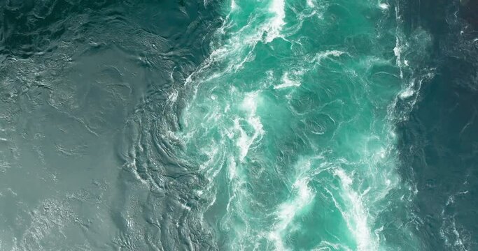 Tidal vortex and whirlpools in turquoise Saltstraumen maelstrom current; drone