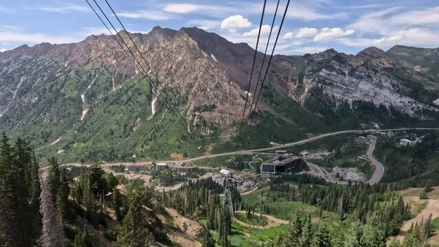 Summer ski tram snowbird mountain Utah descend. Summer and winter all season mountain resort. Vacation nature family fun destination. Recreation on rides, activities and events.