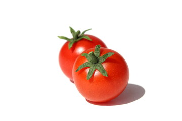 Two red tomatoes lie on a white background.