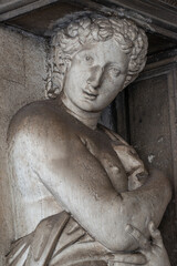 Portrait with a ancient statue of a beautiful woman, Greek or Italian as a telamon at San Macro Square in Venice, Italy