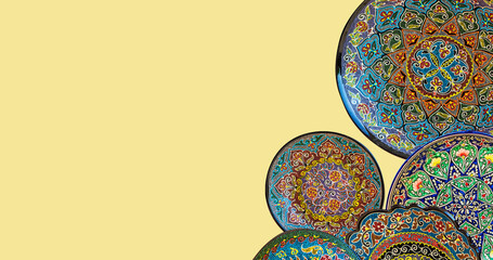 Set of traditional uzbek ceramics, handmade colorful plates. Isolated, solid color background, banner, copy space. Tashkent, Uzbekistan