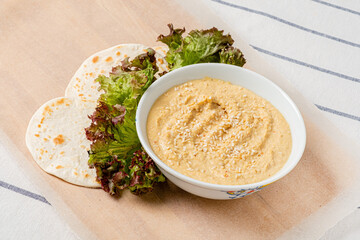 .Chickpeas hummus with flatbread and salad.
