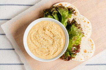 .Chickpeas hummus with flatbread and salad.
