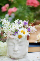 Buddha statue with flowers in the garden. Selective focus.