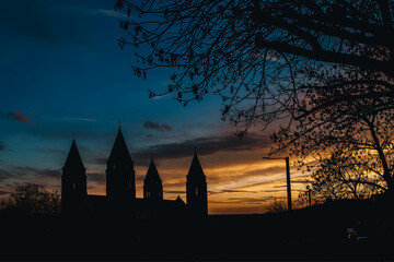 Silhouette of four towers christian cathedral at night in Pecs, Hungary