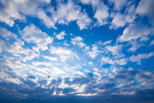 Cloud formations on stormy blue evening sky in Laveno Italy with dramatic shades of blue and grey. Summer sunlight after heavy rain shower, changable weather conditions. Background with high contrast.