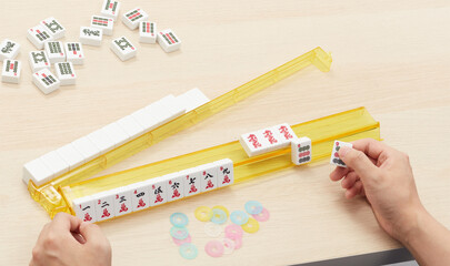 China Mahjong(majiang), close-up, Chinese board game(Translation: mahjong terms, east, west, south, north, middle, fortune)