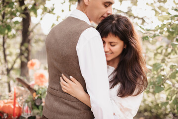 Fototapeta premium Romantic mood. A man in love gently embraces his girlfriend.