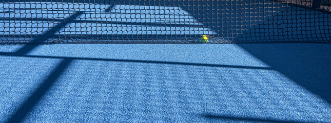 Padel court details with blue floor, net details and shadows