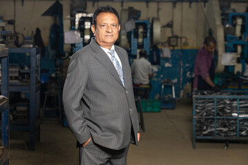 Indian businessman standing at factory