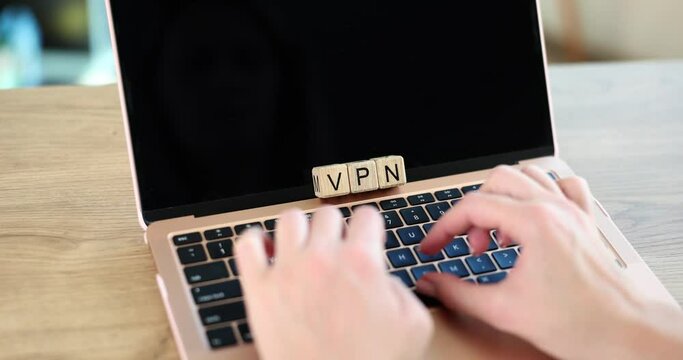 Wooden cubes with inscription vpn and hands on keyboard. Free VPN proxy anonymity