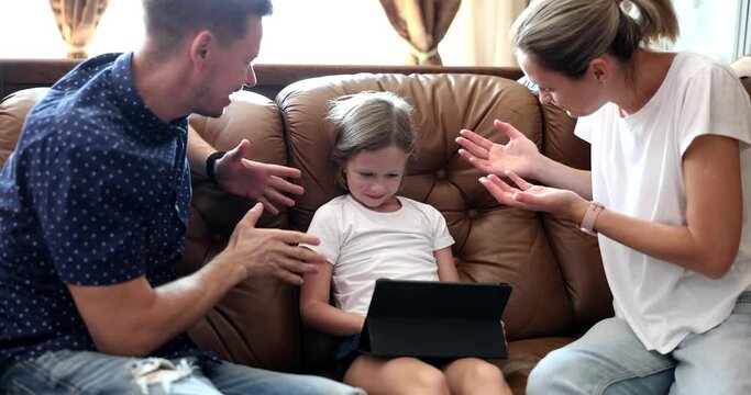 Stop playing parents persuade and scold child daughter for tablet. Children addiction to gadgets and quarrels with children