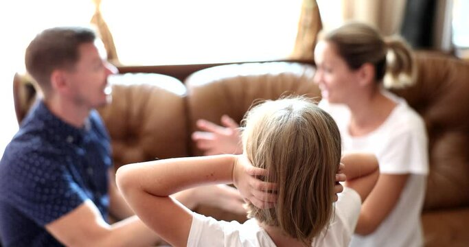 Parents scream quarrel child plugs ears at home. Family quarrels stress and divorce