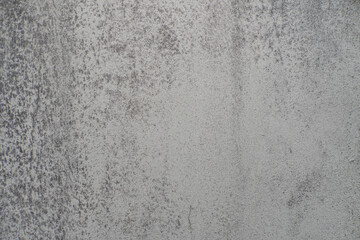 The white concrete wall has stains and cracks texture.