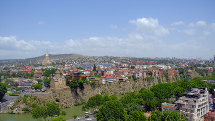 Fototapeta na wymiar landscape old Town and houses of Tbilisi , Georgia from Above Narikala fort: Holy Trinity Cathedral, Tranquil Lake Views, Peace Bridge Charm, Nmetekhi St. Virgin Church Heritage Zion Cathedral Majesty