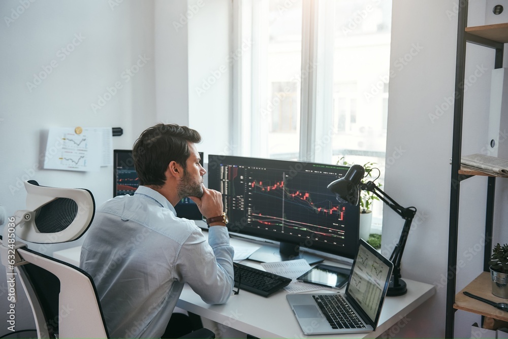 Poster trading on world markets. young stock market broker analyzing data and graphs on multiple computer s
