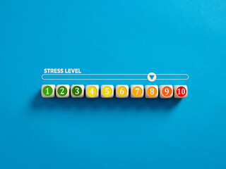 Indicator measuring stress level. High level of stress. Stress level numbers on wooden cubes with a...